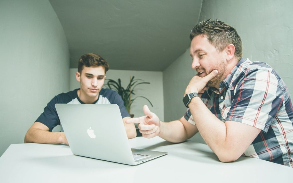 Tutor and learner working together at a laptop in a one-to-one lesson